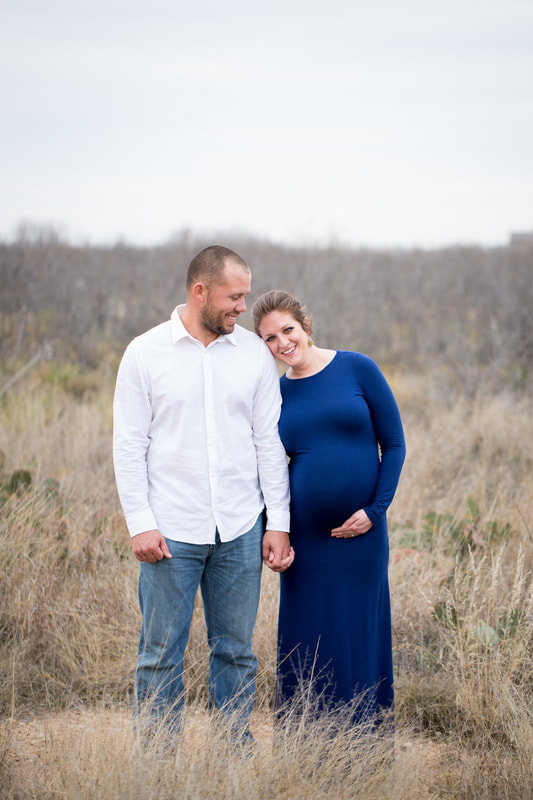 Maternity Couple in field, blue dress